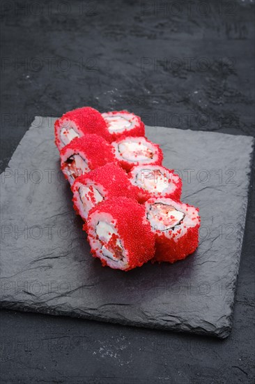 Rolls with shrimp and flying fish roe on slate plate