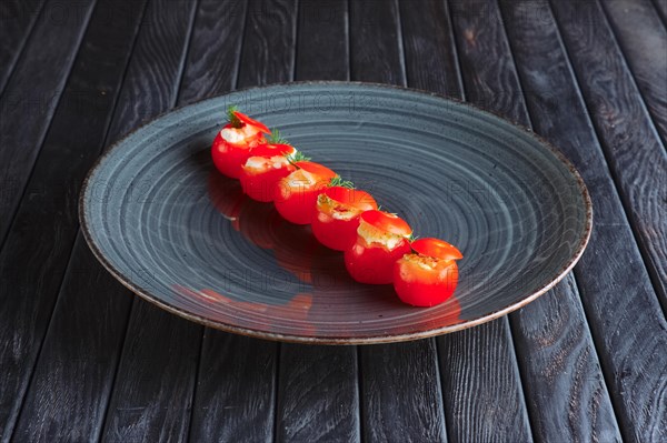 Appetizer for reception. Tomato cherry stuffed with mozzarella end egg