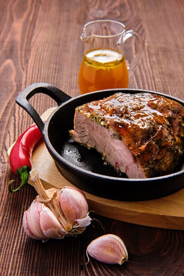 Closeup view of oven-baked meat with braised cabbage and zucchini and hot spicy sauce