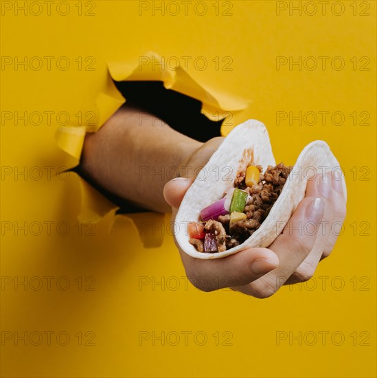 Close up hand holding taco