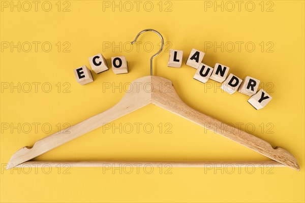 Top view wooden hanger with yellow background. Resolution and high quality beautiful photo