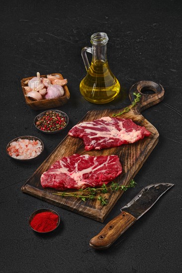 Overhead view of black table with raw fresh beef spider steak