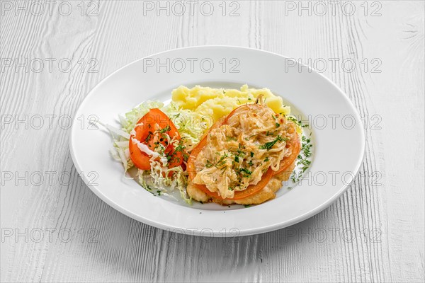 Plate with chopped meat backed with tomato with buckwheat and cabbage salad