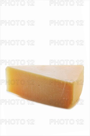 Triangle piece of parmesan cheese isolated on white background