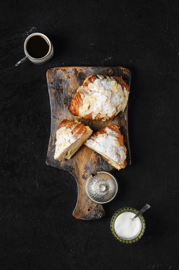 Top view of crispy croissant on wooden serving board