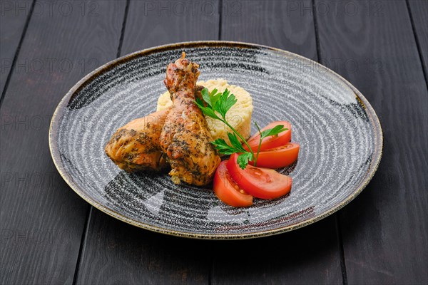 Portion of fried chicken leg with millet porridge