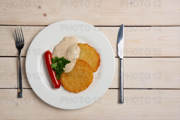 Portion of potato frlapjack with smoked sausage and mustard sauce