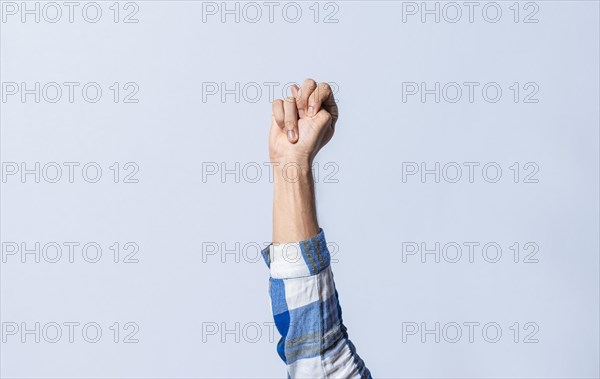 Hand gesturing the letter N in sign language on an isolated background. Man's hand gesturing the letter N of the alphabet isolated. Letter N of the alphabet in sign language