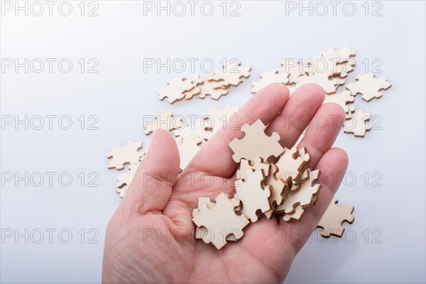 Hand holding piece of jigsaw puzzle as problem solution concept