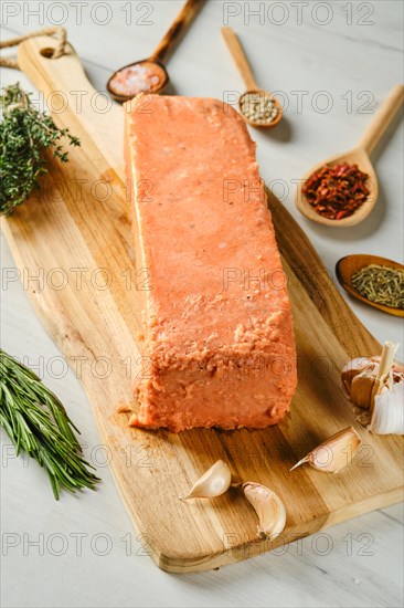 Raw pieces of salmon pressed in briquette with spice and herbs