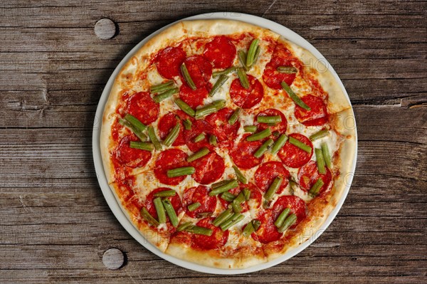 Top view of pizza pepperoni on wooden background