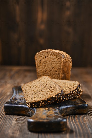 Closeup view of fresh rye brown bread on wooden cutting board