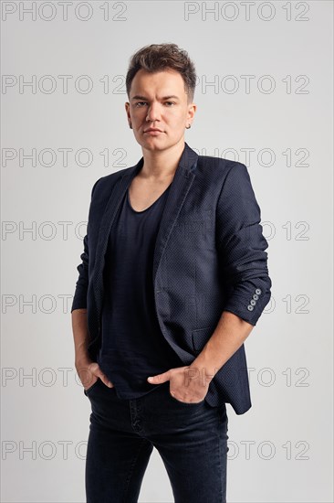 Portrait of serious man in jeans