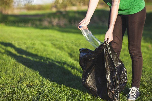 Recycle concept with woman collecting trash