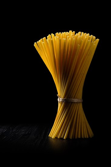 Low key photo of whole wheat ziti pasta. Organic tube spaghetti