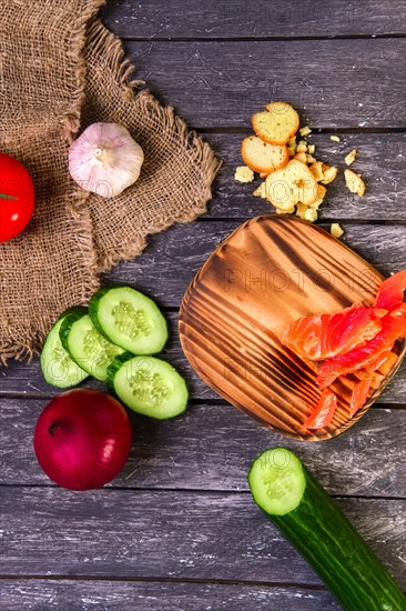 Fresh vegetables on wooden board with a napkin on a table