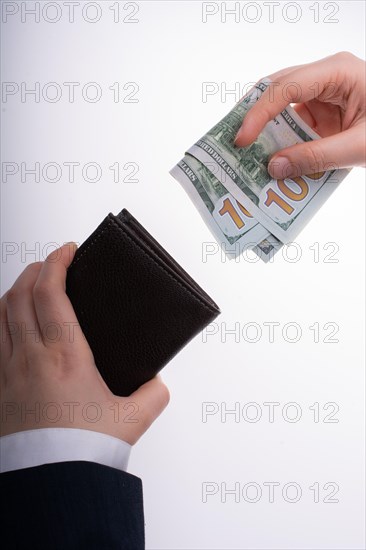 Businessman with dollar banknotes and wallet on white background