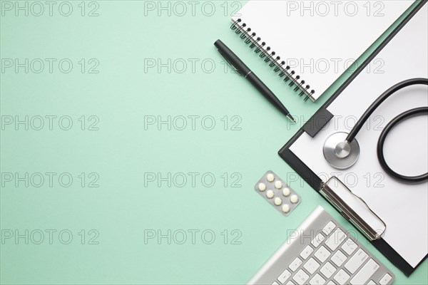 Stethoscope blister pack pill with office supplies green background. Resolution and high quality beautiful photo
