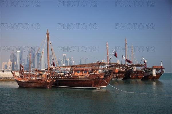 Fishing boats in front of the skyline of Doha