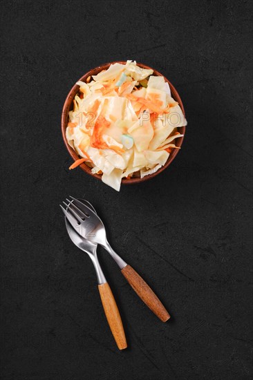 Overhead view of clay bowl with homemade pickled cabbage