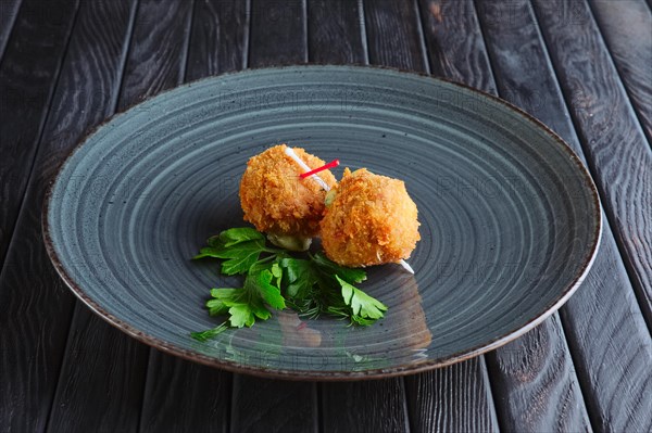 Appetizer for reception. Fried mozzarella balls rolled in bacon in breading