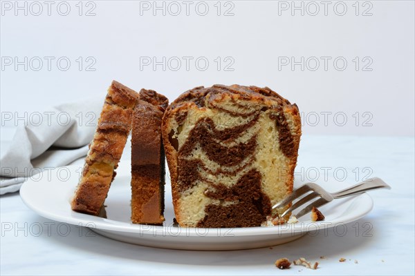 Marble cake with cake fork on plate