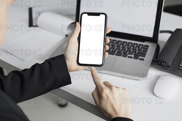 Close up worker holding mobile phone