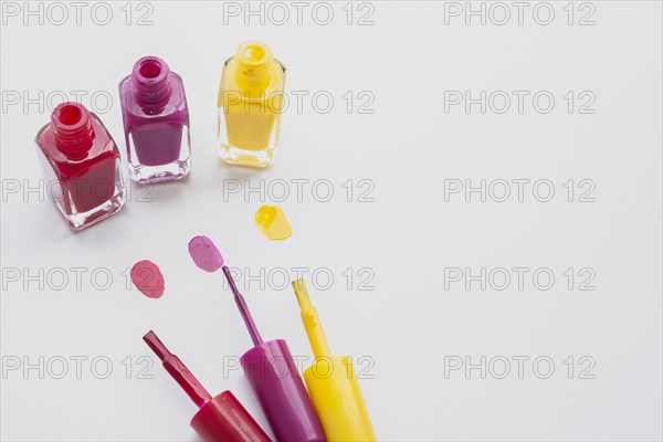 High angle decoration with nail polishes white background