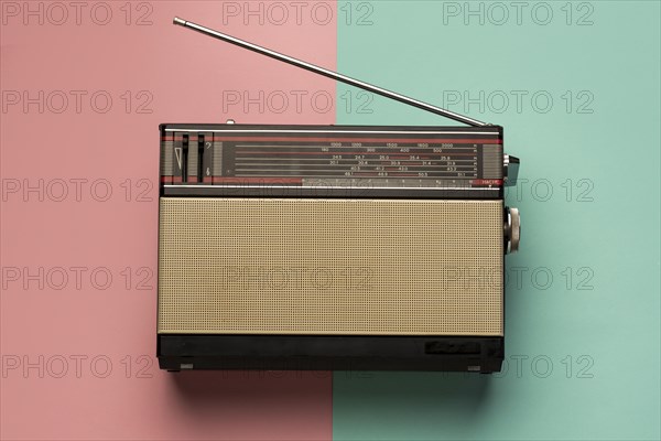 Retro broadcast radio receiver pink light blue background