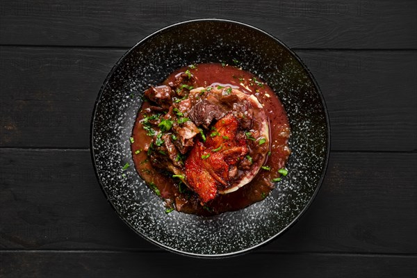 Top view of beef goulash with bacon chips