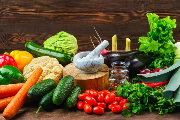 Assortment of fresh vegetables on dark wooden background