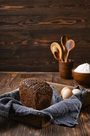 Fresh rye brown bread on wooden cutting board