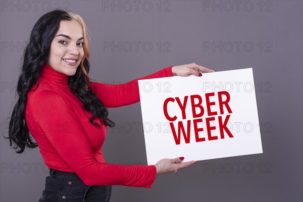 Beautiful woman holding a Cyber Week sign. Commercial concept. Commerce