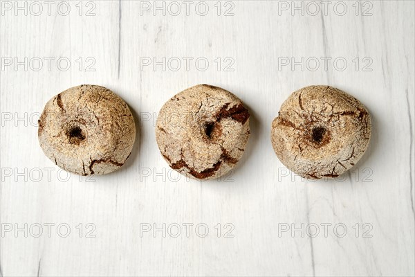 Homemade buns for burger made from rye grain on kitchen table