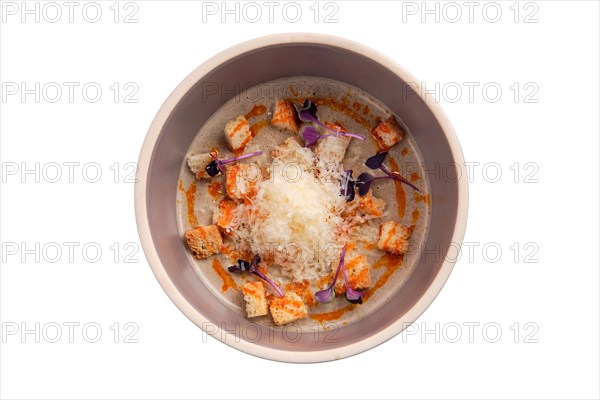 Mushroom soup puree with sheese and croutons isolated on white background