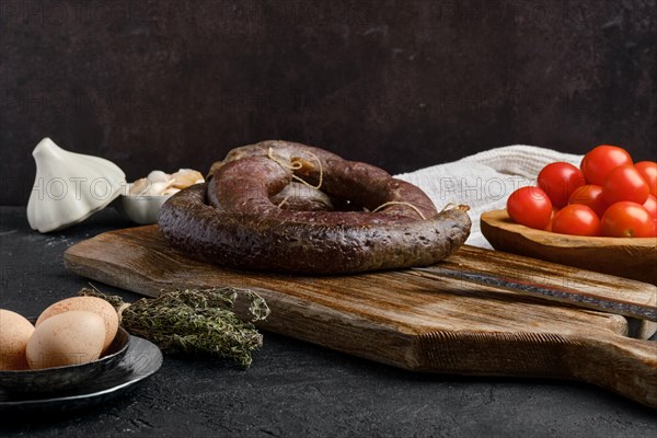 Blood sausage rolled on wooden cutting board