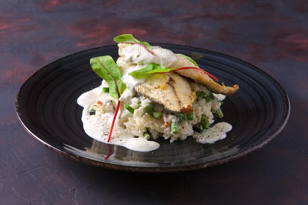 Fried fillet of white fish with rice and green beans decorated with chard