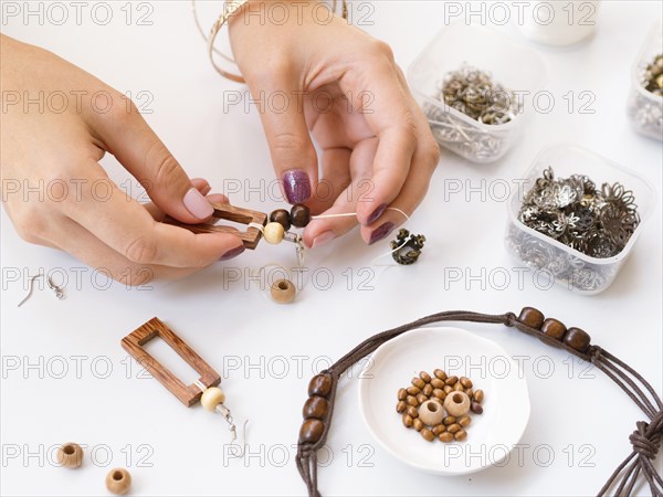 Woman making accessories with wooden beads. Resolution and high quality beautiful photo