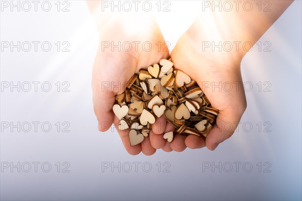 Retro style wooden hearts in hand as love concept