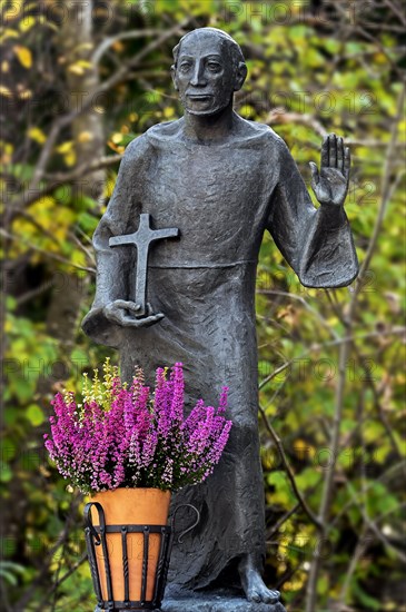 Nepomuk statue with flower decoration in autumnal Ostrachtal