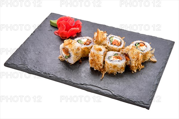 Smoked salmon rolls with cucumber on slate plate isolated on white