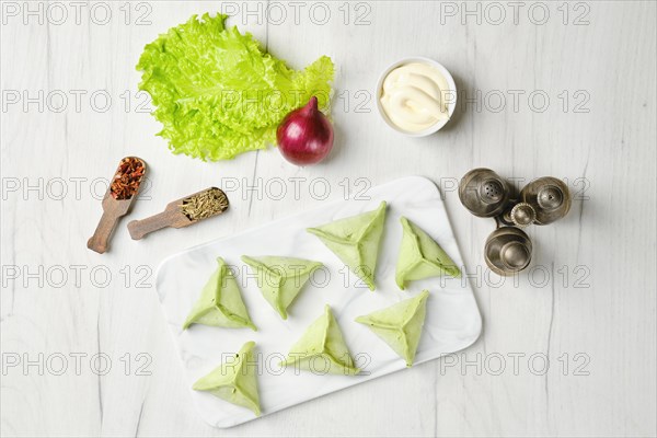 Overhead view of frozen dumplings with spinach