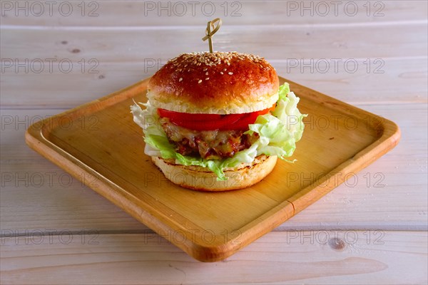 Pulled beef burger on wooden plate