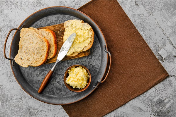 Top view of plate with homemade soft cheese spreaded on bread