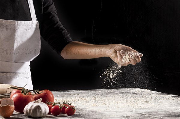 Close up hand holding flour