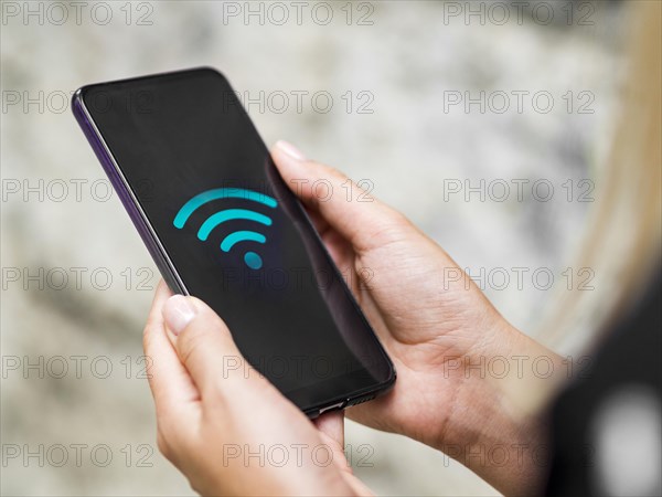 Close up phone hands with wifi symbol