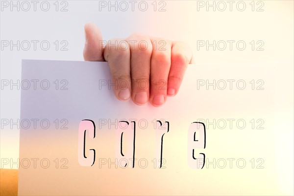 Hand holding care word on a white background