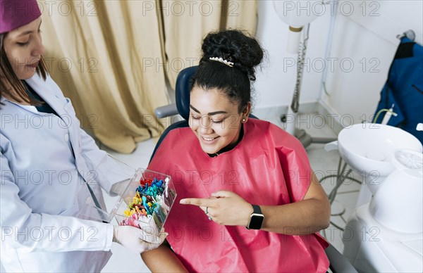 Patient with dentist choosing dental braces