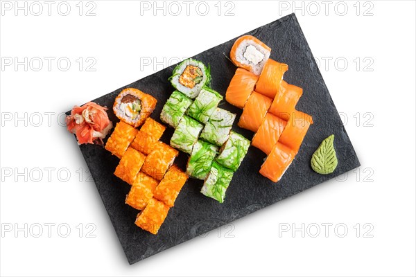 Set of rolls with wasabi and pickled ginger on stone serving board