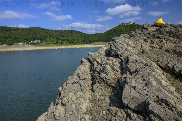 Dry buoy at low water in front of Waldeck Castle in Lake Edersee